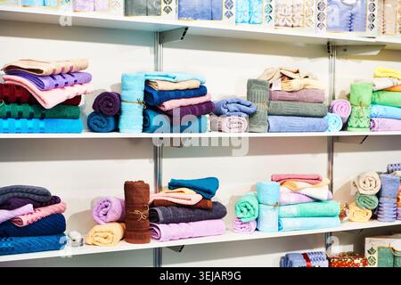 Colored terry towels on a shelf in a spa salon Stock Photo