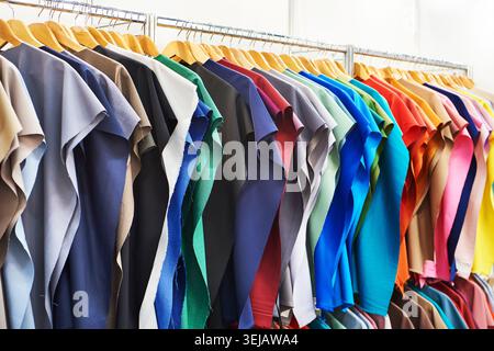 Fabric for sewing clothes on hangers in a store Stock Photo