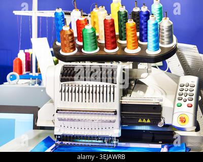 Industrial embroidery machines in a sewing workshop Stock Photo