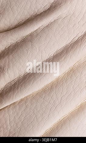 Natural beige leather texture. Useful as background for design-works. Close-up, vertical Stock Photo