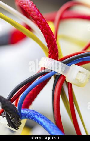 Multicolored electrical cables isolated close up. Vertical image. Selective focus Stock Photo
