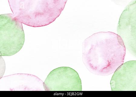 Abstract watercolor artwork with pink and green circular shapes on white background Stock Photo