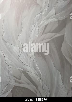 Soft, light grey fabric shows flowing lines and a texture that shimmers under different angles of light. The design creates a wave-like appearance on Stock Photo