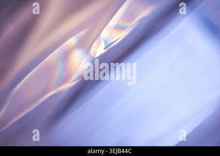 Abstract light refraction with soft pastel colors creating a playful rainbow effect on a smooth texture Stock Photo