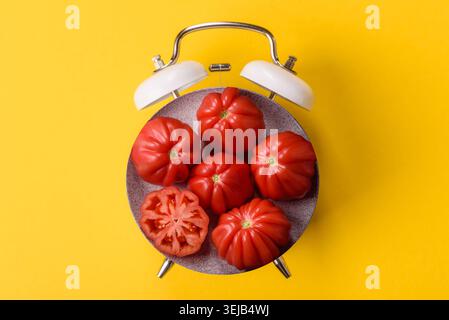 Fresh pink heirloom ribbed tomatoes as an ingredient for a lunch salad. Ribbed heirloom tomatoes as a background for your design Stock Photo