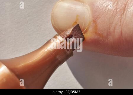 Close up of fingernail with brown felt tip marker stain on skincare enhanced surface Stock Photo