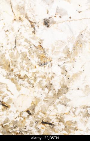 Close-up view of a stone surface featuring intricate patterns in shades of white, gold, and gray, showcasing the beauty and uniqueness of natural marb Stock Photo
