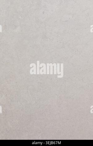 A smooth, textured wall displays a range of soft white tones. Daylight illuminates the surface, highlighting its subtle variations and creating an inv Stock Photo