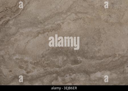 This view showcases a natural stone surface featuring soft, earthy tones and intricate patterns, perfect for interior decoration. The smooth texture a Stock Photo