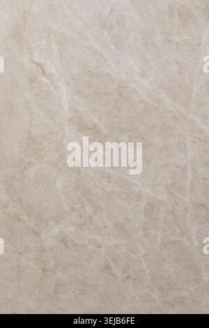 A smooth, natural beige marble surface features delicate veining, suitable for various home decor and design applications. Ideal for countertops or fl Stock Photo
