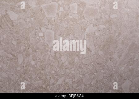 This surface showcases a light beige stone with unique patterns and textures, ideal for flooring or wall applications in various design settings. Perf Stock Photo