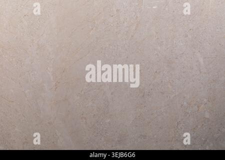 This surface showcases a beautiful beige marble with subtle veining, well-lit by natural light, highlighting its smooth texture and understated elegan Stock Photo