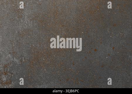 Close-up view of a rusty metal surface exhibiting various textures and colors. The background highlights the effects of time and exposure, creating a Stock Photo