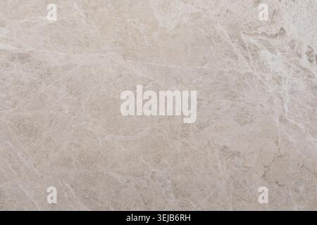 This light beige marble features soft veins and a smooth surface, ideal for countertops or flooring. The natural stone offers a classic and timeless l Stock Photo