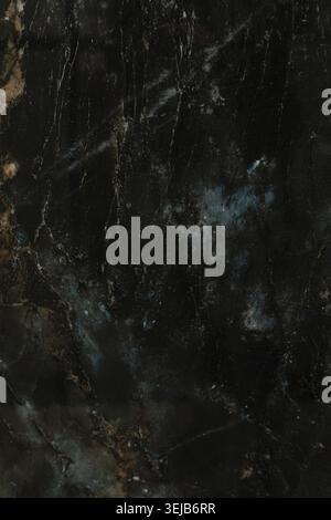 This dark marble surface features intricate patterns with hints of blue and gold, highlighting the rich texture and natural elegance of the stone, per Stock Photo