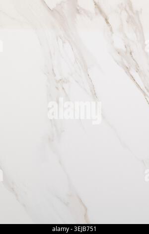 A smooth white marble surface showcases delicate grey veins, suitable for various design applications like countertops and flooring. Its timeless eleg Stock Photo