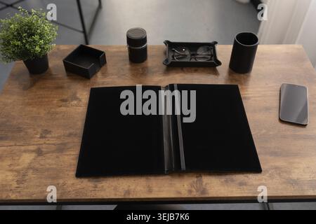 Workplace in the office with a leather folder for papers on the table Stock Photo