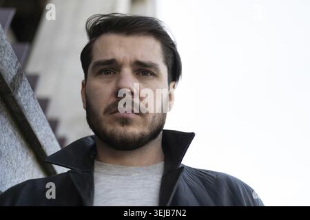 Close-up portrait of a man without nationality looking at the camera during a depression outside Stock Photo
