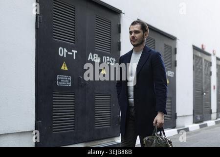Business man adult caucasian engineer goes to work with a briefcase Stock Photo