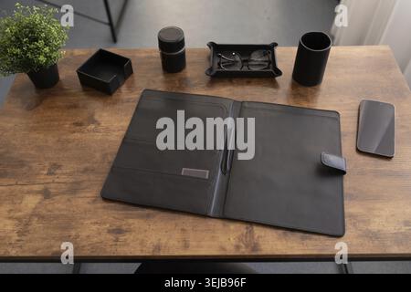 Office desk with stationery leather folder for papers and documents Stock Photo