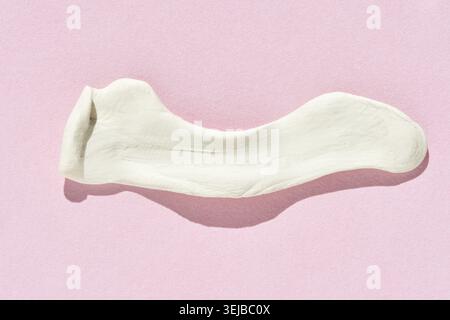White sock on pink background showing casual design and soft material texture Stock Photo