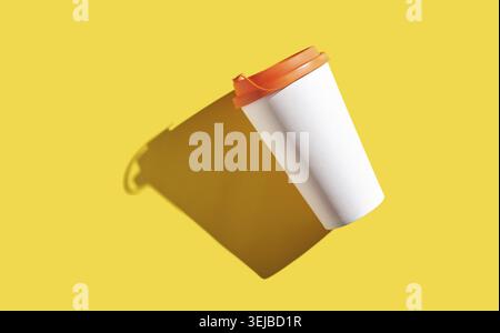 Floating white coffee cup with orange lid on yellow background casting shadow Stock Photo