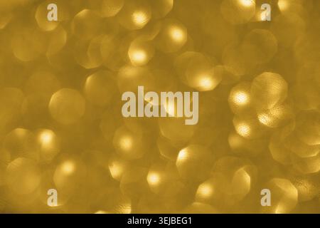 Golden bokeh background with soft circular light patterns creating a warm, glowing abstract effect Stock Photo
