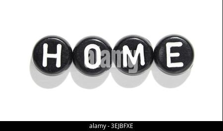 Black round letter blocks spelling home on white background for interior design and home decor concepts Stock Photo