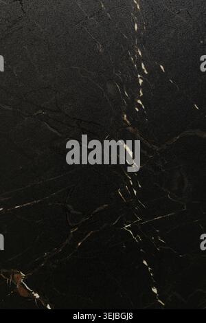 The black marble surface features striking white veins creating a beautiful and sophisticated look. Ideal for countertops, flooring, or decorative acc Stock Photo