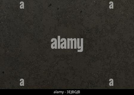 The dark textured surface displays a variety of subtle patterns and tones, creating an interesting backdrop for design projects and artistic expressio Stock Photo