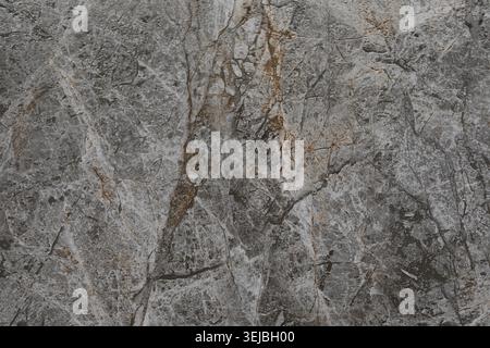 This surface features a unique gray marble with natural veins and intricate patterns. The texture highlights the complexity and beauty of natural ston Stock Photo