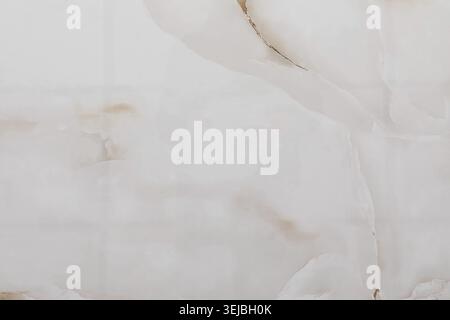 The smooth surface of white marble features soft textures and delicate veins. This elegant material is ideal for countertops or flooring in modern spa Stock Photo