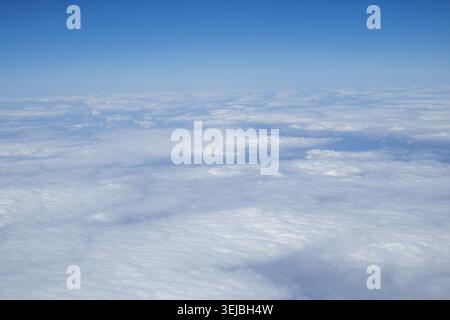 Soft White Clouds Viewed From Airplane Above The Sky During Flight. Stock Photo
