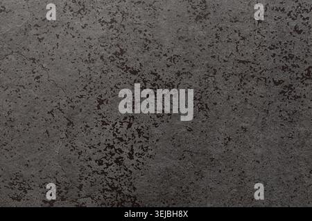 A close-up view of a textured gray concrete surface showcases subtle patterns and variations. The rough surface highlights natural imperfections, crea Stock Photo