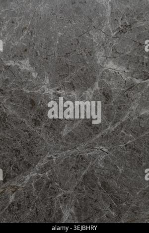 A close-up view of a gray marble surface with unique veining and textures. This stone can be used in various home decor projects, providing a timeless Stock Photo