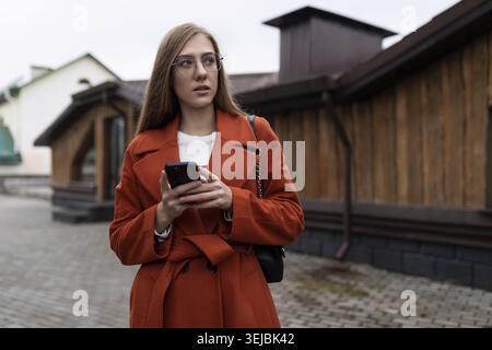 Business young caucasian woman with a smartphone in her hands Stock Photo