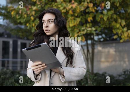 Businesswoman with a tablet on the background of the office center Stock Photo