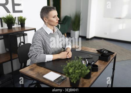 Woman worker in the office sitting at the table Stock Photo