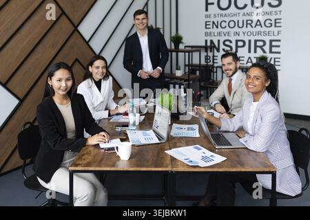 Young co-workers team talking during startup - Happy people planning a new project in creative workplace Stock Photo