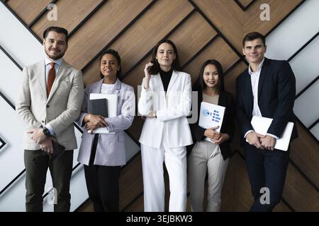 Portrait of successful creative business team looking at camera and smiling. Diverse business people standing together at startup Stock Photo
