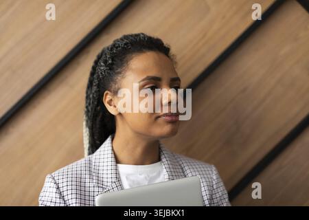 Portrait of happy multiethnic businesswoman using digital tablet in agency Stock Photo