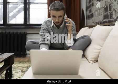 Businesswoman working on startup project sitting with laptop Stock Photo