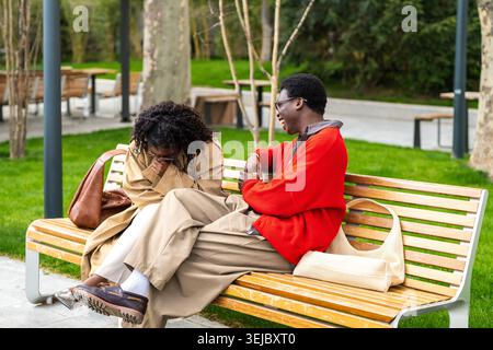 Cheerful african american couple man and woman joking laughing together while spending time on date. Stock Photo