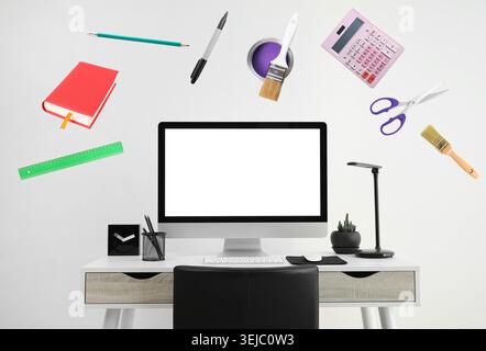 Web design tools flying around computer. Creative designer workspace Stock Photo