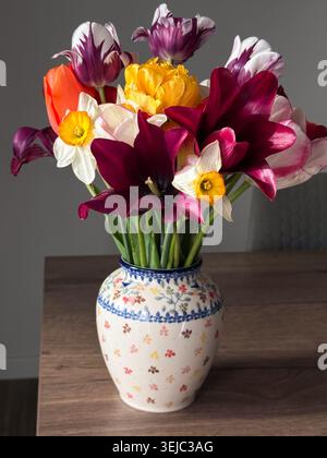 Colorful spring flowers blooming in decorative ceramic vase Stock Photo