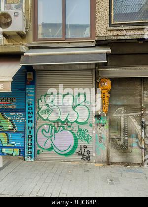 Istanbul, Turkey - July 20, 2024: City views. Graffiti on closed-up retail shop facades in Necatobey Cd shopping street Stock Photo