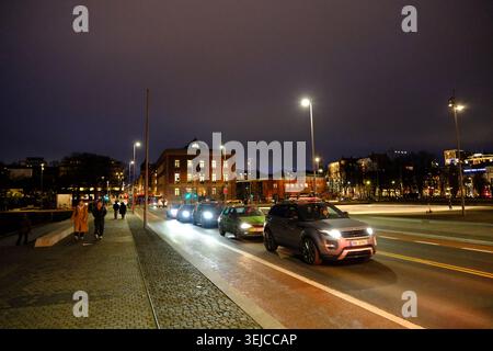 Oslo, Norway-Nov.25th 2025: cars driving on Operagata street next to the Opera House in Oslo, Norway at night. Stock Photo