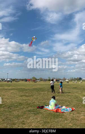 Family Flying Colorful Character Kite at International Kite Festival - Blue Sky with White Clouds Stock Photo