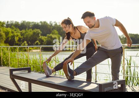 Young fit and active couple doing sport exercising in nature. Outdoors fitness concept. Stock Photo