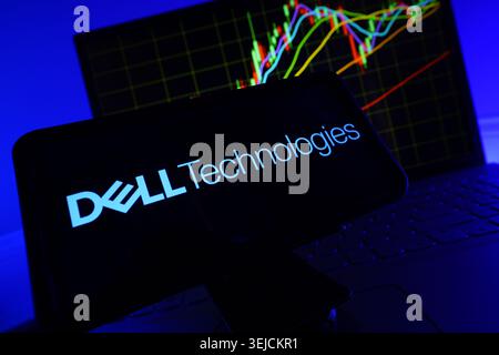 Dell Technologies Corporation Logo Displayed On Screen With Financial Stock Chart Background And Vibrant LED Lighting Stock Photo